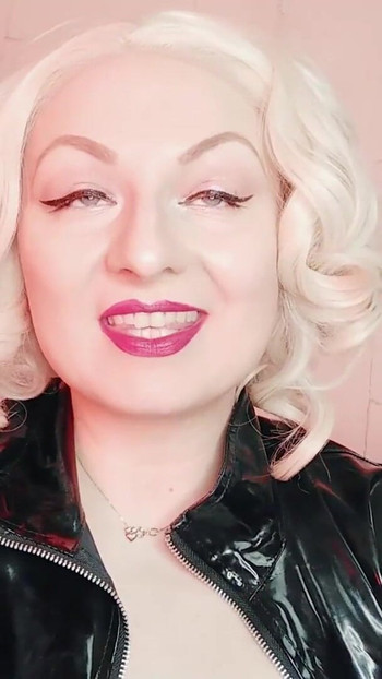 Key moment from "rude FemDom JOI jerk off instructions in PVC coat - fetish porn - Mistress Arya Grander"