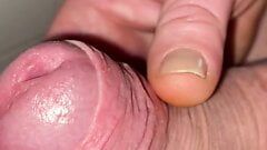 Close-up slowly revealing foreskin and cock head