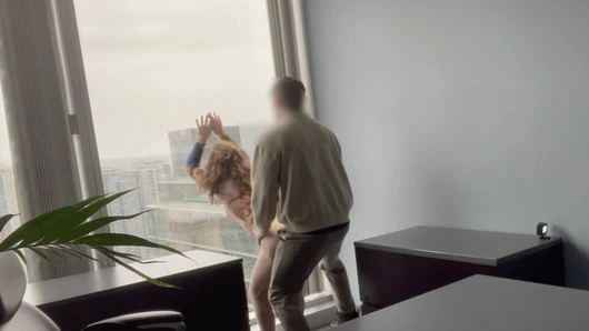 MILF boss fucked against her office window