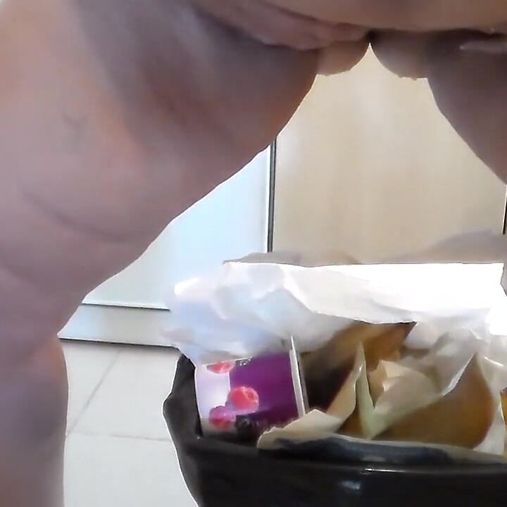 Jen is peeing into the trash can