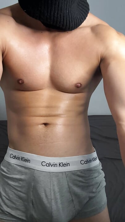Masked horny hunk oiled up and teasing