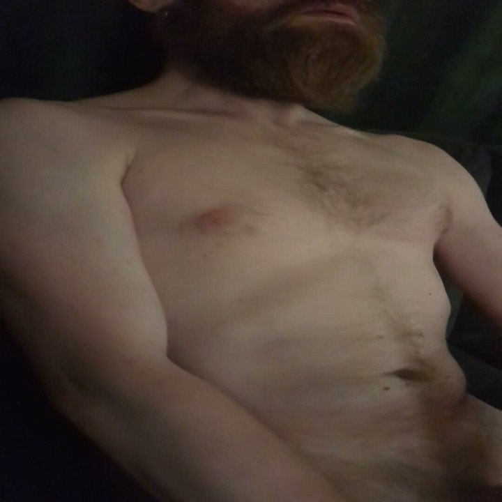 Nude male masturbating on couch