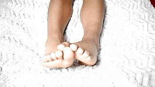 Luscious feet on a beautiful white sheet