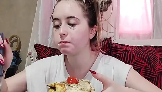 Eating an omelette sandwich with cherry tomatoes