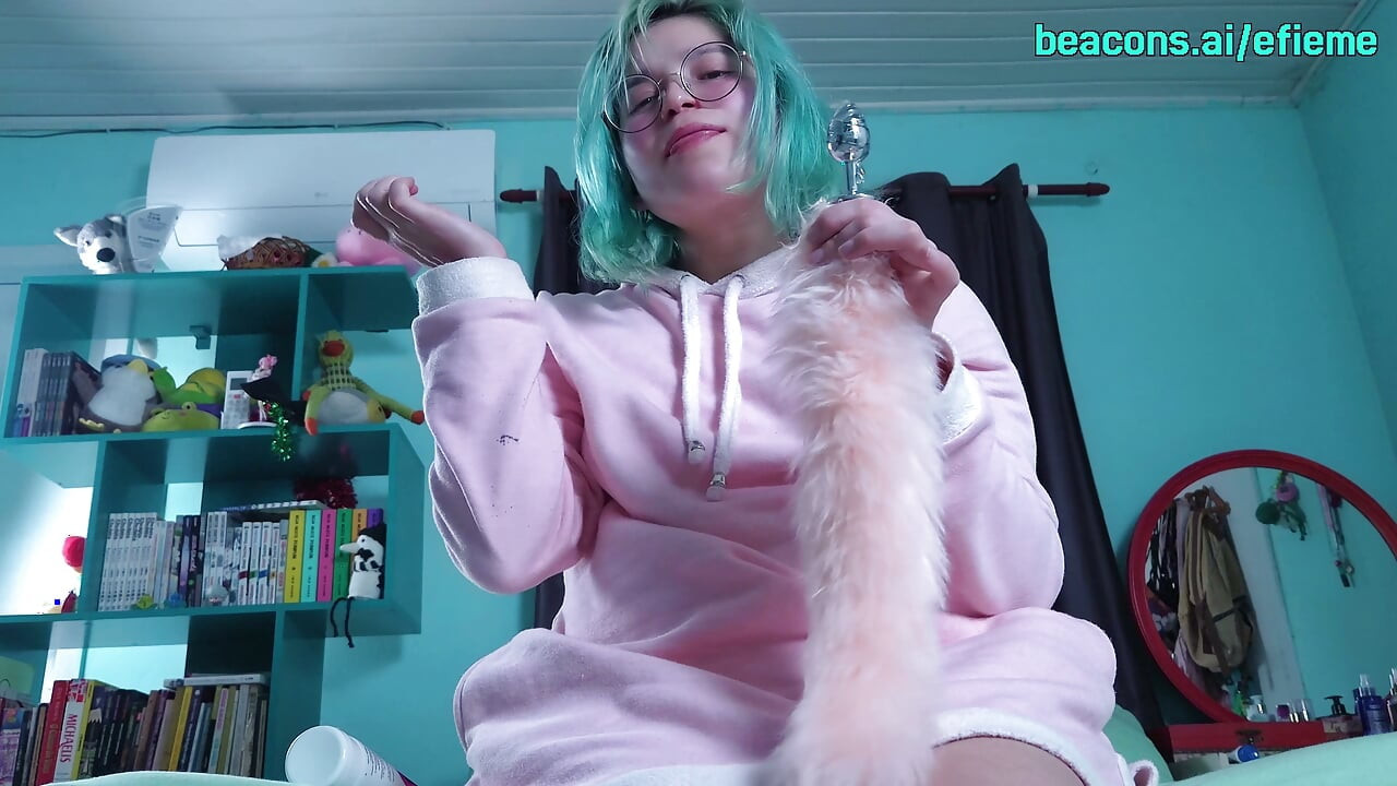 Nerdy chick puts on a tail butt plug, sucks a dildo and shoves it into her pussy