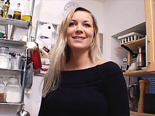 Outstanding German MILF with huge boobs dildoing her shaved muff in the kitchen
