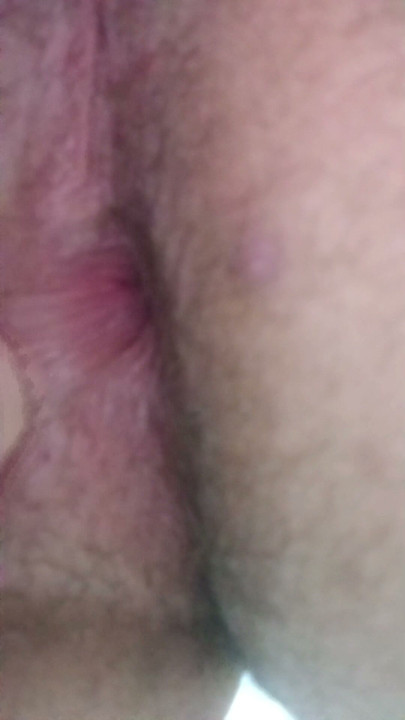 Scratching her ass with her fingertip