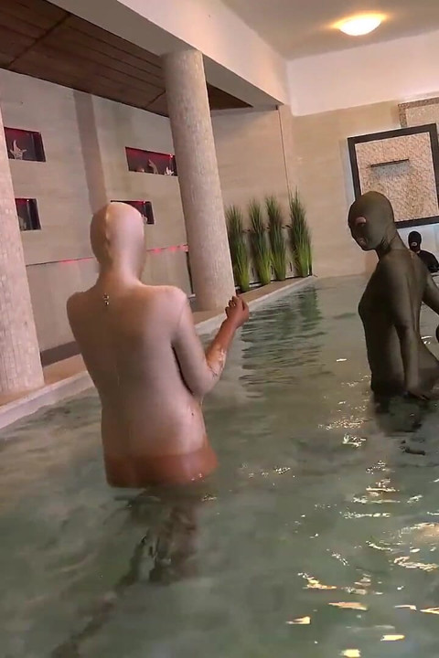 Two Zentai Girls with Slave in Pool