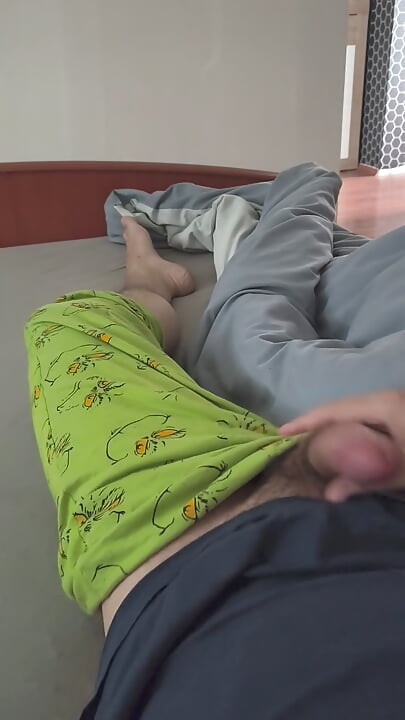 Cute handjob on the bed with a hard and erect penis