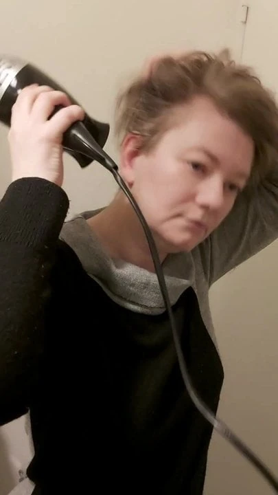 Mistress Ravenia is drying her hair