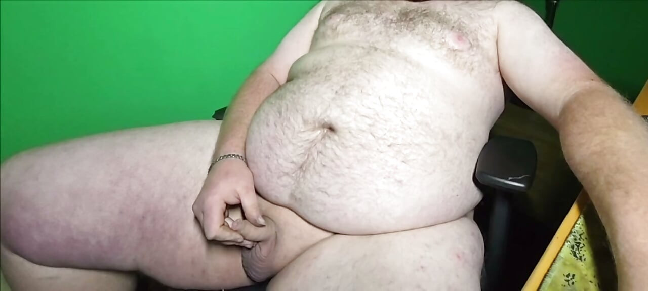 A fat boy with a small dick is masturbating.