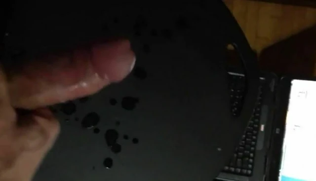 Kon Dix big cock shoots a load of cum on a black table