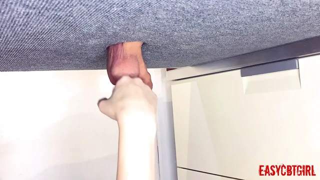 Mistress tickles the slave's balls with her fists and slaps