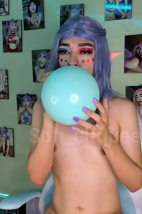 Young girl blowing and playing with balloons