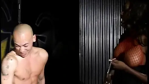 Nyomi Banxxx bends over a slaveboy for butt flogging then has him eat her boots