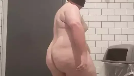 Chubby guy strips naked in bathroom.