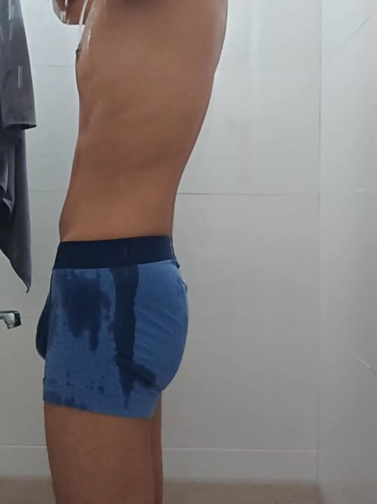 Teen indian boy taking shower