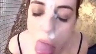 Shooting cum on the slut's face in the backyard