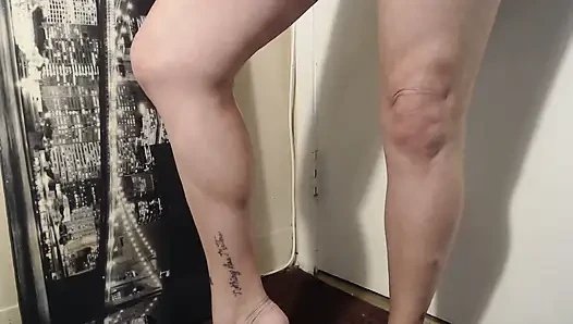 Oiled calves flexing calve muscle