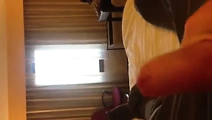 Stroking uncut cock by hotel window