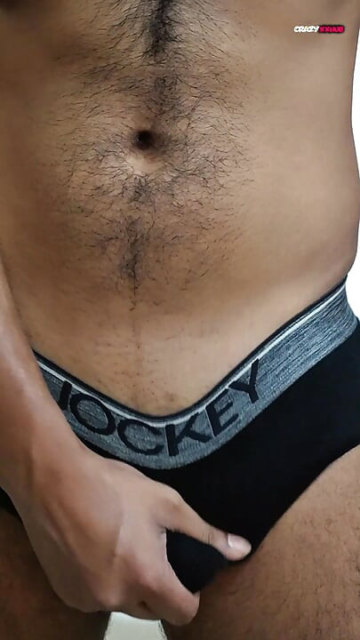 A sexy guy is dancing while holding his cock.