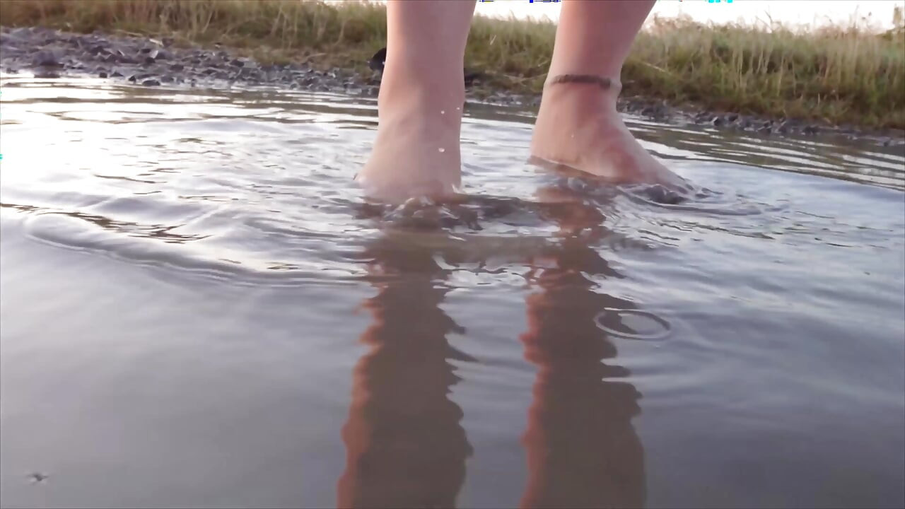 Bright Pantyhose and Beach Shoes in Puddle