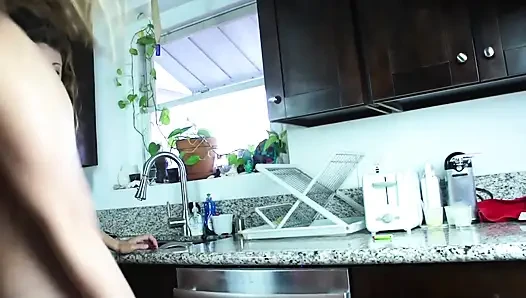 Two lesbian teens scissoring each other in the kitchen