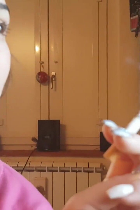 Tempting Italian girl smokes a cigar in a close up video
