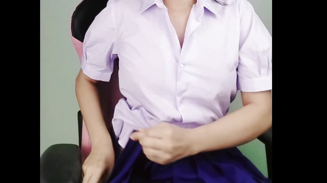 A sexually aroused high school girl is playing with her genitals using a dildo on a wooden chair. RealThaiSolo