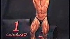 Bodybuilder's dick comes over top of posers on stage
