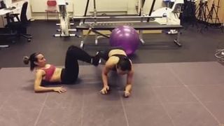 Ali Riley & Marta workout in sports bras and leggings