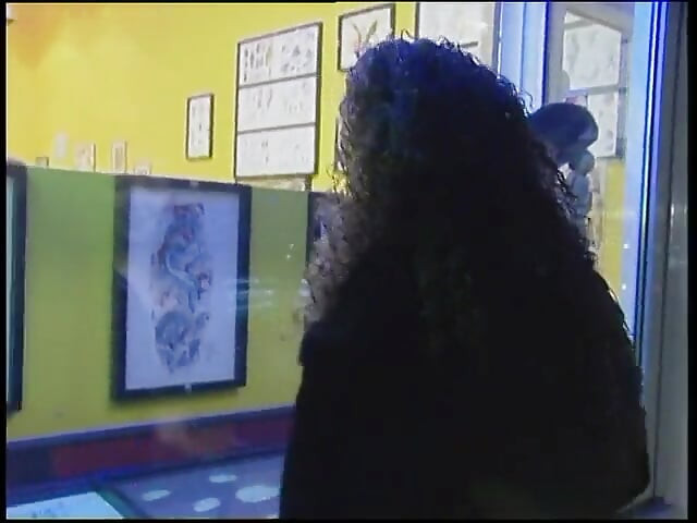 Fabulous brunette with curly hair wants a new tattoo