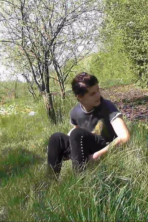 Pissing in grass on the side of the road