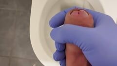 Jerking doctor at a toilet with latex gloves