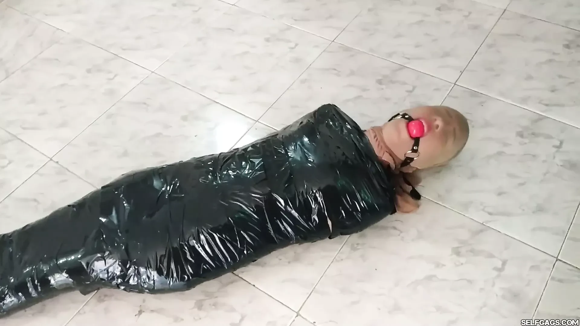 Tape Mummified Girl in Pantyhose Hooded And Ball Gagged