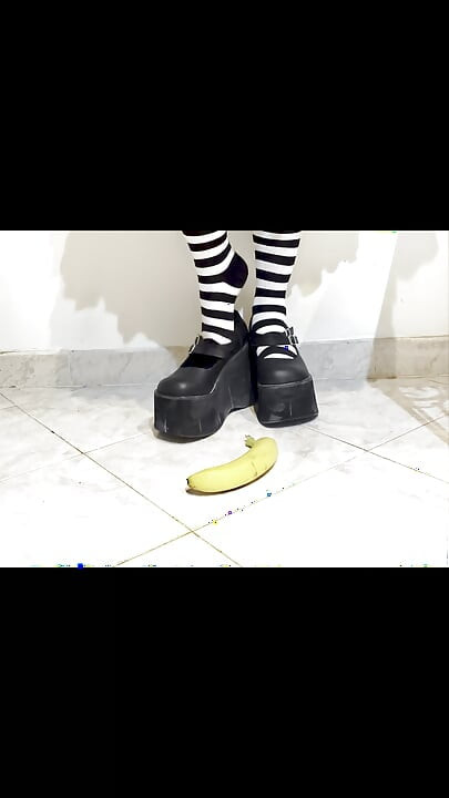 Goth crushing a banana under her shoes