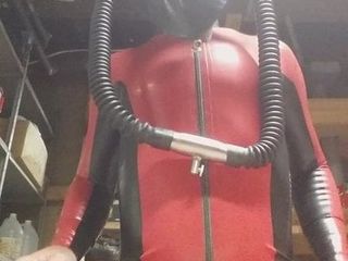 Latex catsuit and heavy rubber helmet