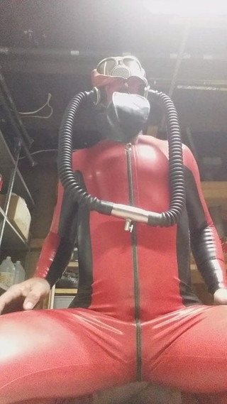 Latex catsuit and heavy rubber helmet