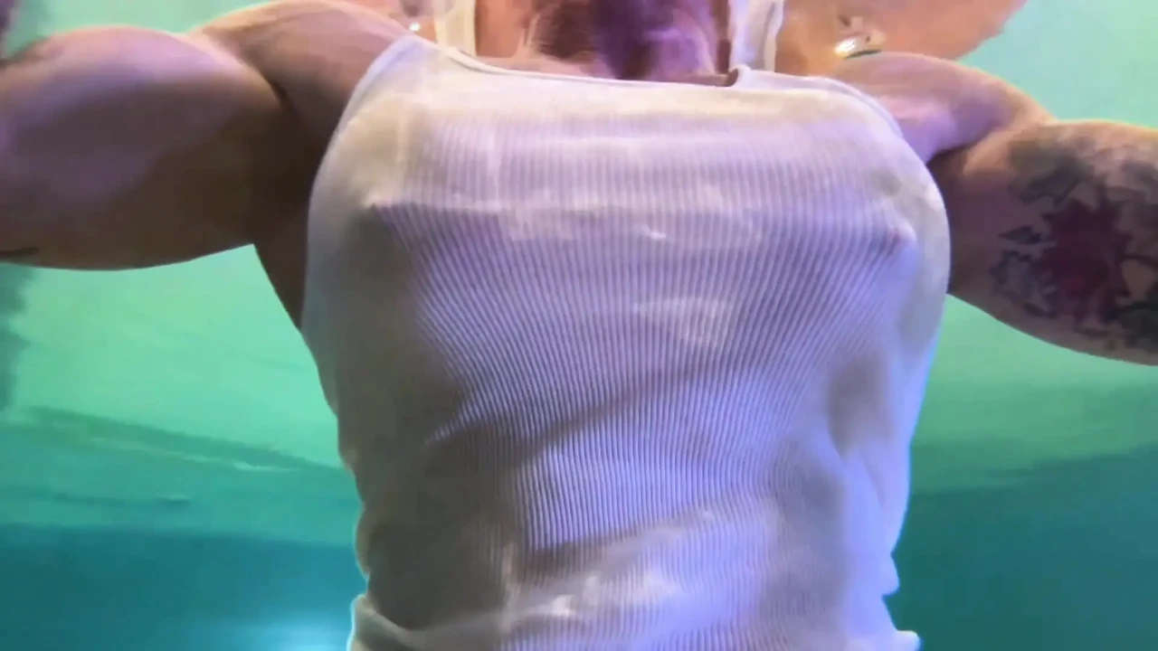Amazon Kandy Flexes Her Massive Biceps in Her Hotel Pool
