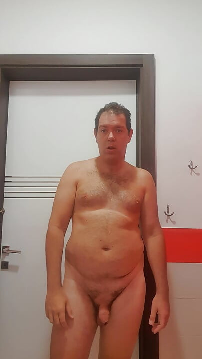 A boy completely naked in a station bathroom