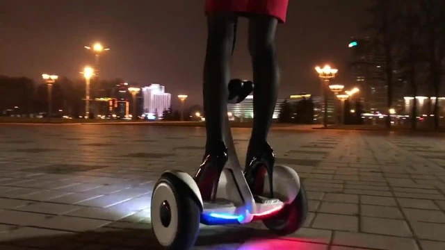 Hot girl driving gyroscooter in high heels and short skirt