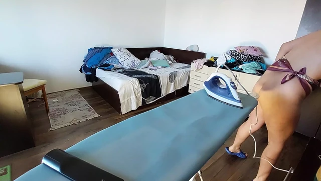 Amateur woman does nude housework. MILF with hairy pussy, big ass. Amateur woman prepares naked food in the kitchen.