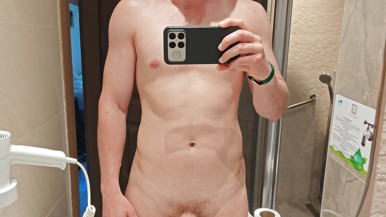 Young man pissing in the sink