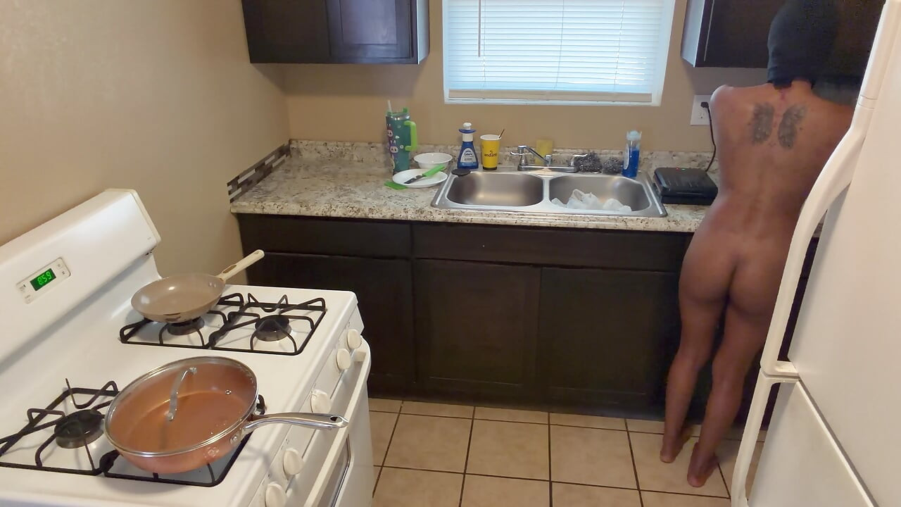 In the kitchen cooking and preparing food booty naked!