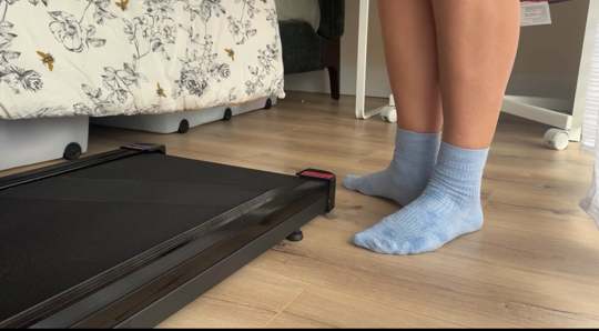 girl takes off wet white socks after treadmill