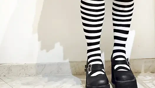 Goth crushing a banana under her shoes