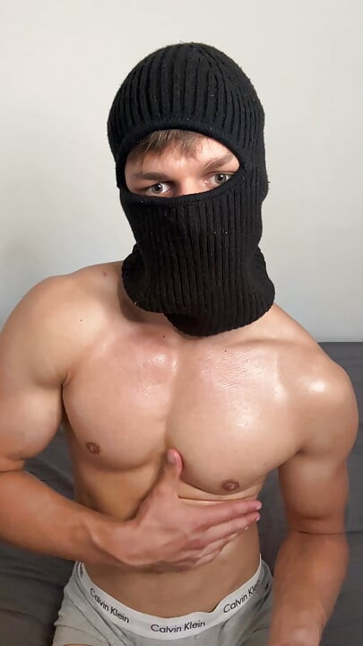 Masked horny hunk oiled up and teasing