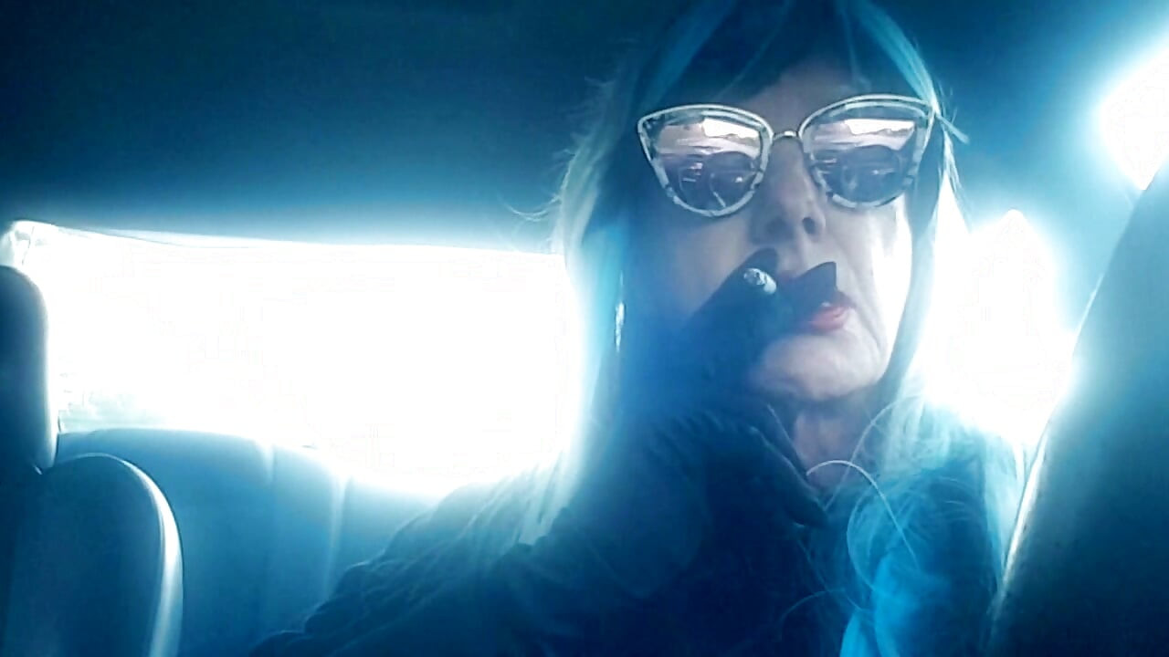 MATURE CD SMOKING & DRIVING WITH A MB100 CIGARETTE IN HER GLOVED HAND