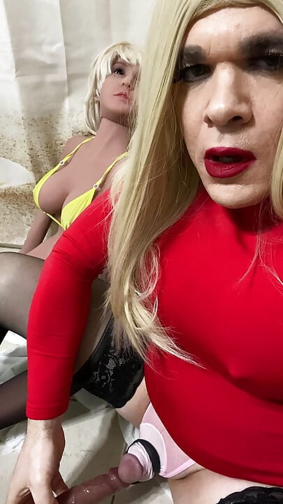 Crossdressing slut and her sex doll suck on a big cock dildo while vibrating cock ring and anal vibrator goes off