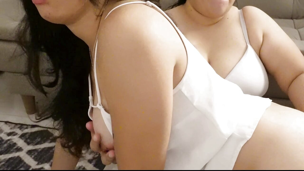 Two girls make scissors in the living room of their house